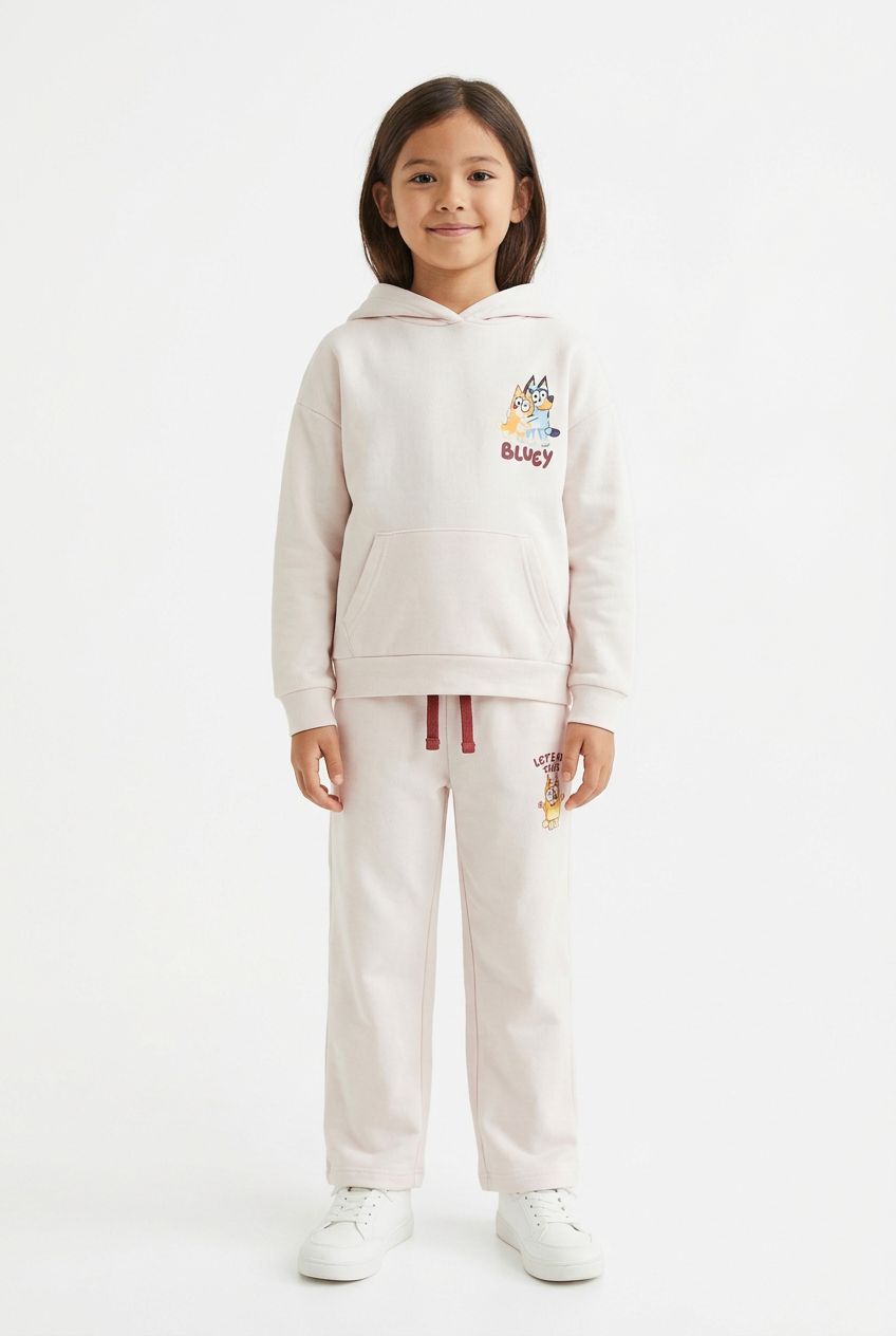 Kid model wearing the Bluey hoodie and trouser set